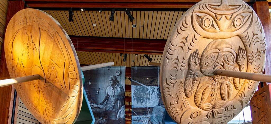 Close-up of large carved cedar welcome figures inside the Squamish Lil’wat Cultural Centre in Whistler.