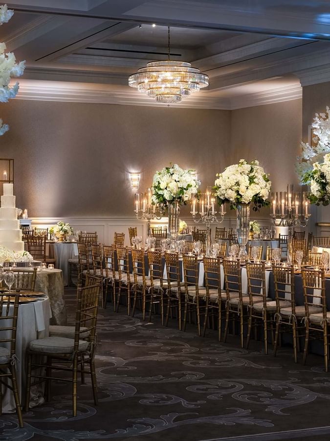 Grand ballroom by floral towers under crystal chandeliers at Warwick Melrose Dallas