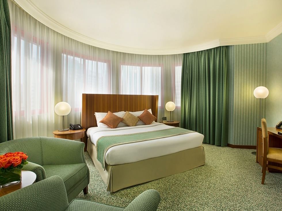 King size bed in Junior Suite bedroom at Al Hamra Abu Dhabi