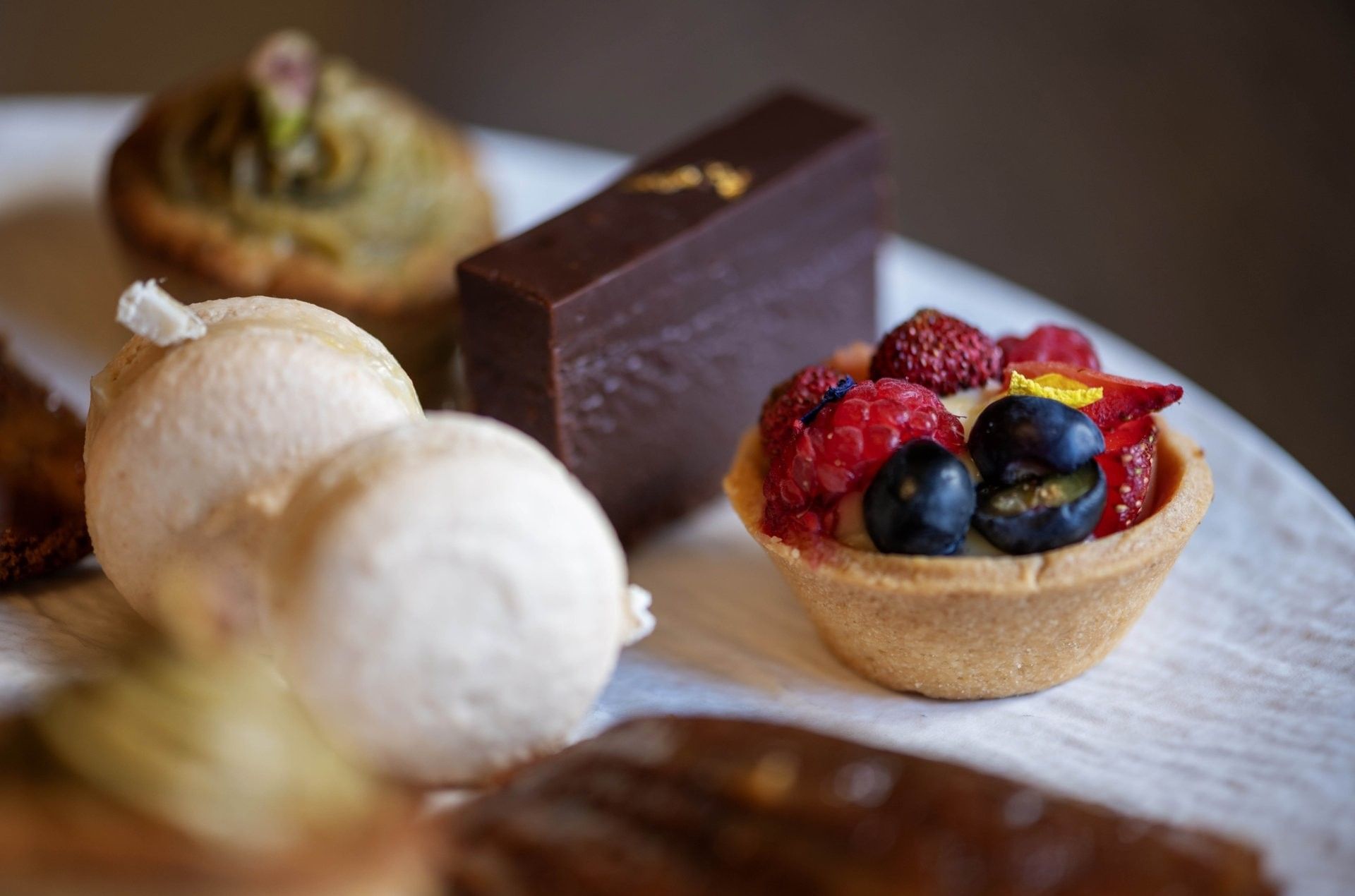 Assortment of gourmet pastries served on a plate at The Capital Hotel, Apartments and Townhouse