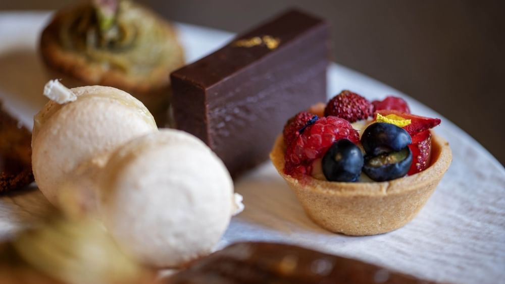 Assorted desserts including berries and chocolate at The Capital Hotel, Apartments & Townhouse - London.