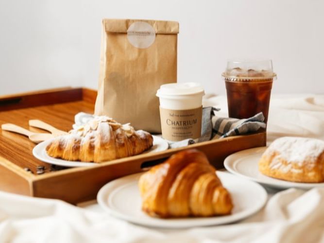 Image of a breakfast tray with freshly baked croissants and coffee.