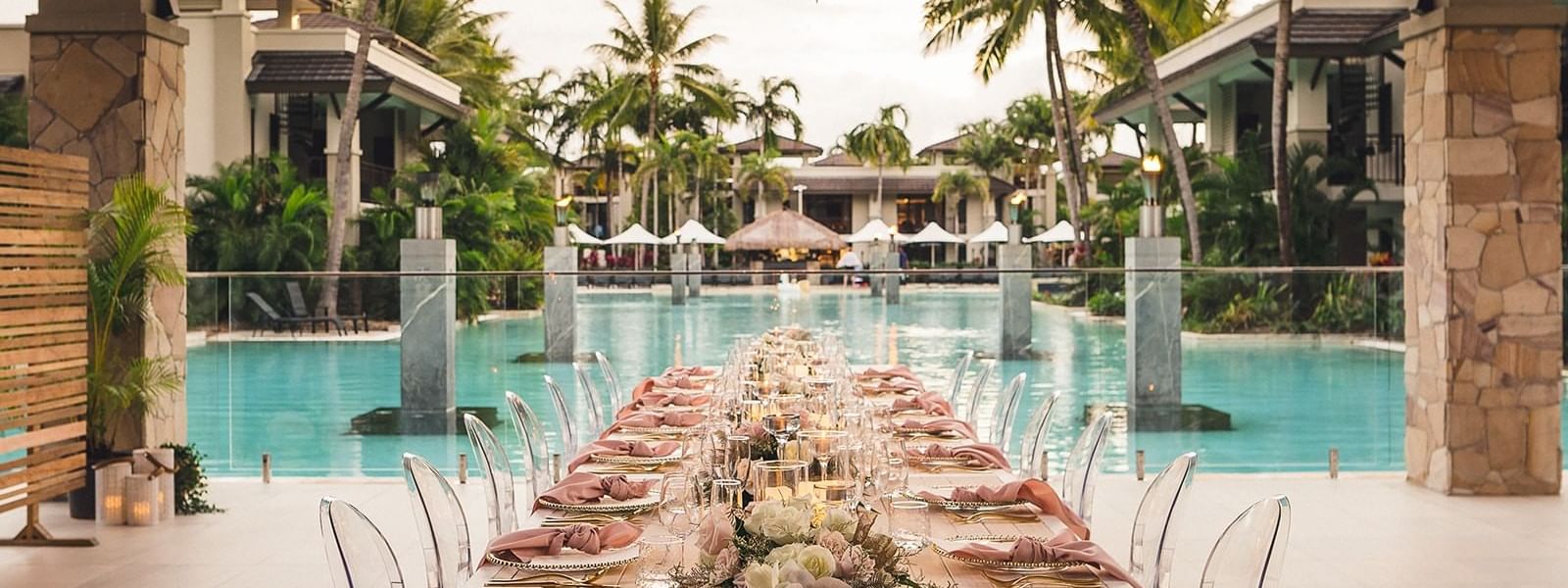 Silhouette of wedded couple under palm trees in sunset at Pullman Port Douglas Sea Temple Resort & Spa
