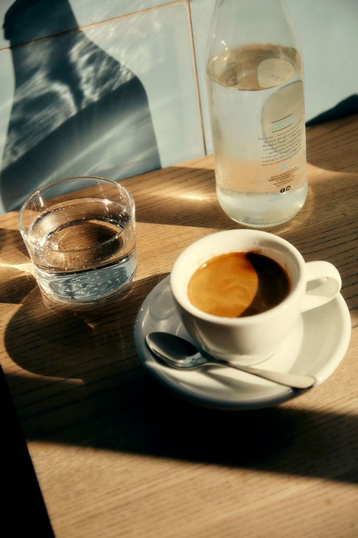 A coffee & water served in Market Lane Coffee near The Kinson
