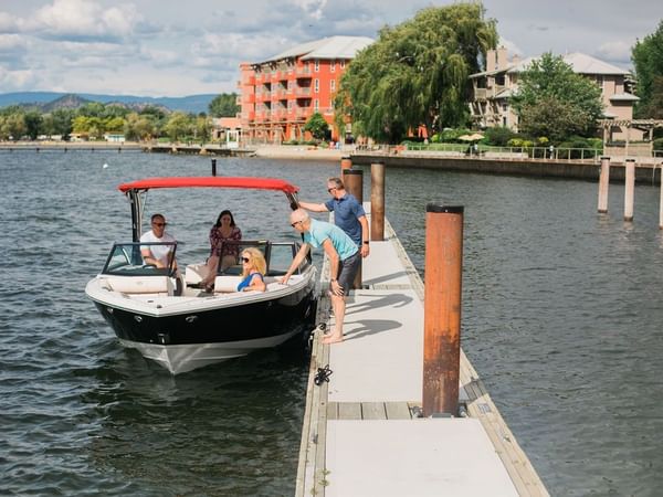 Guests getting on a boat in a lake near Hotel Eldorado