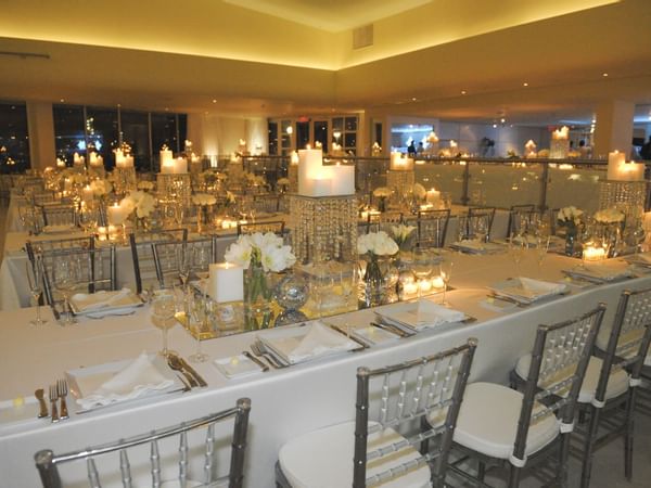 tables arranged with candles in a Wedding hall at Condado Plaza