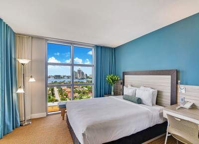 Bed, desk in Deluxe Bayfront Suite at Marenas Resort Miami