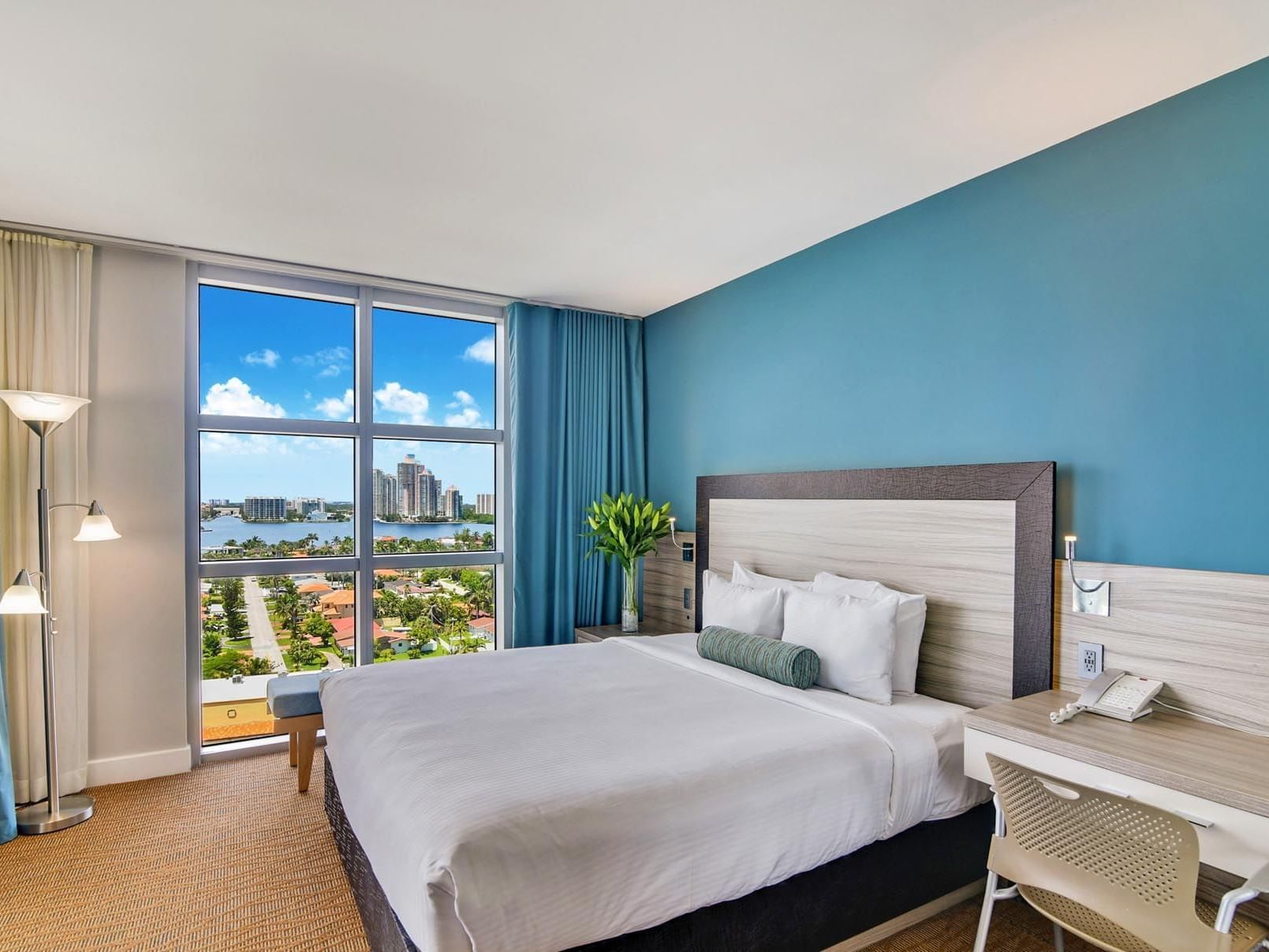 Bed, desk in Deluxe Bayfront Suite at Marenas Resort Miami