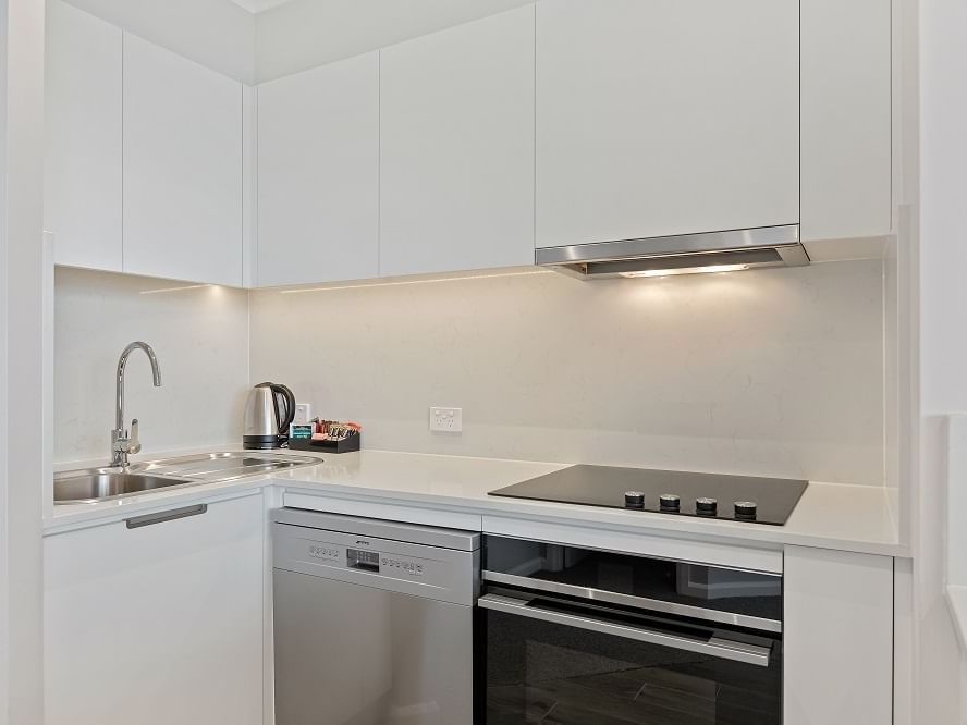 Kitchen with inbuilt oven at The Sebel Quay West Suites Sydney