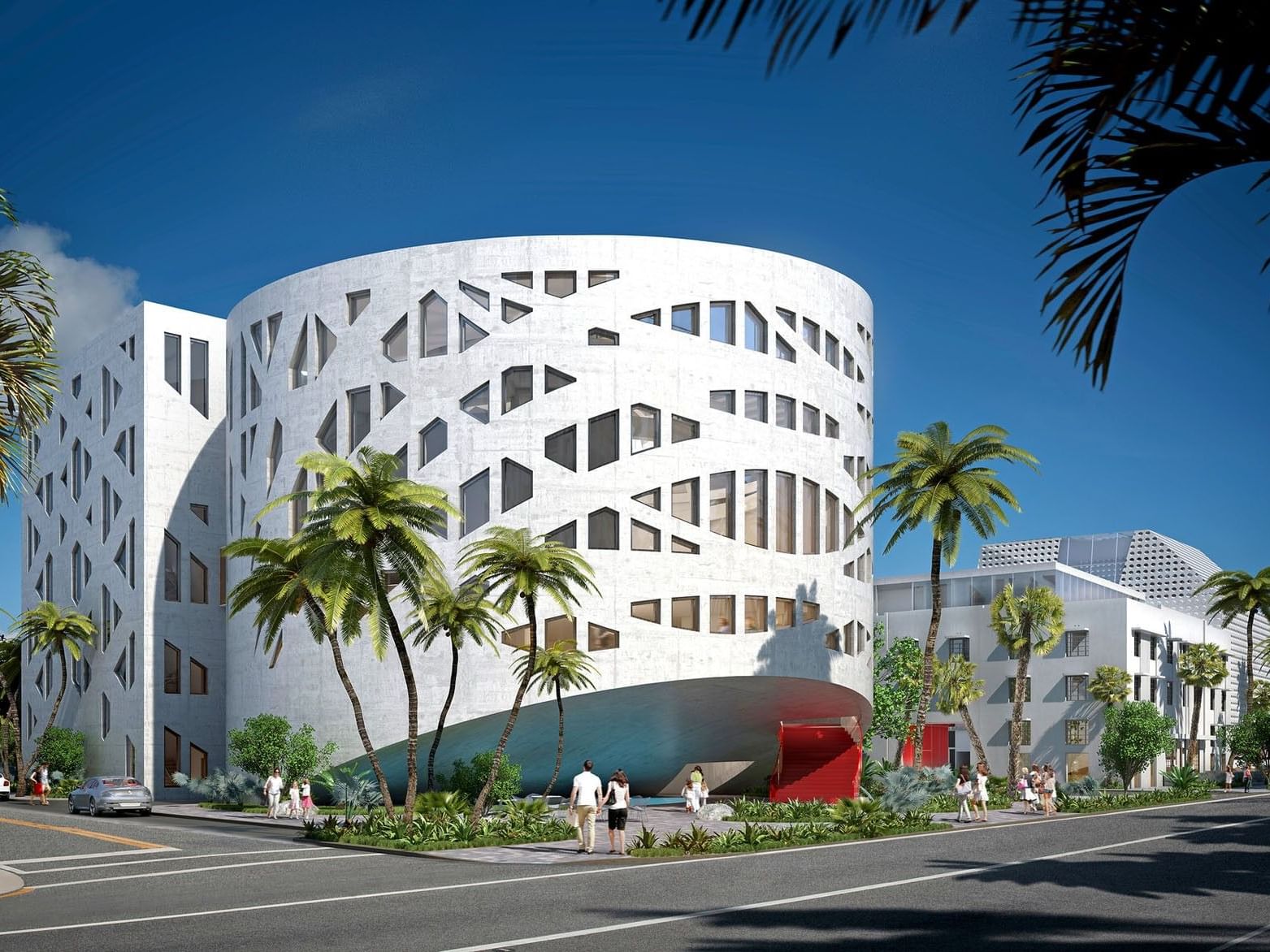Faena District buildings with geometric cutouts and a curved base on a sunny street near Tradewinds Apartment Hotel