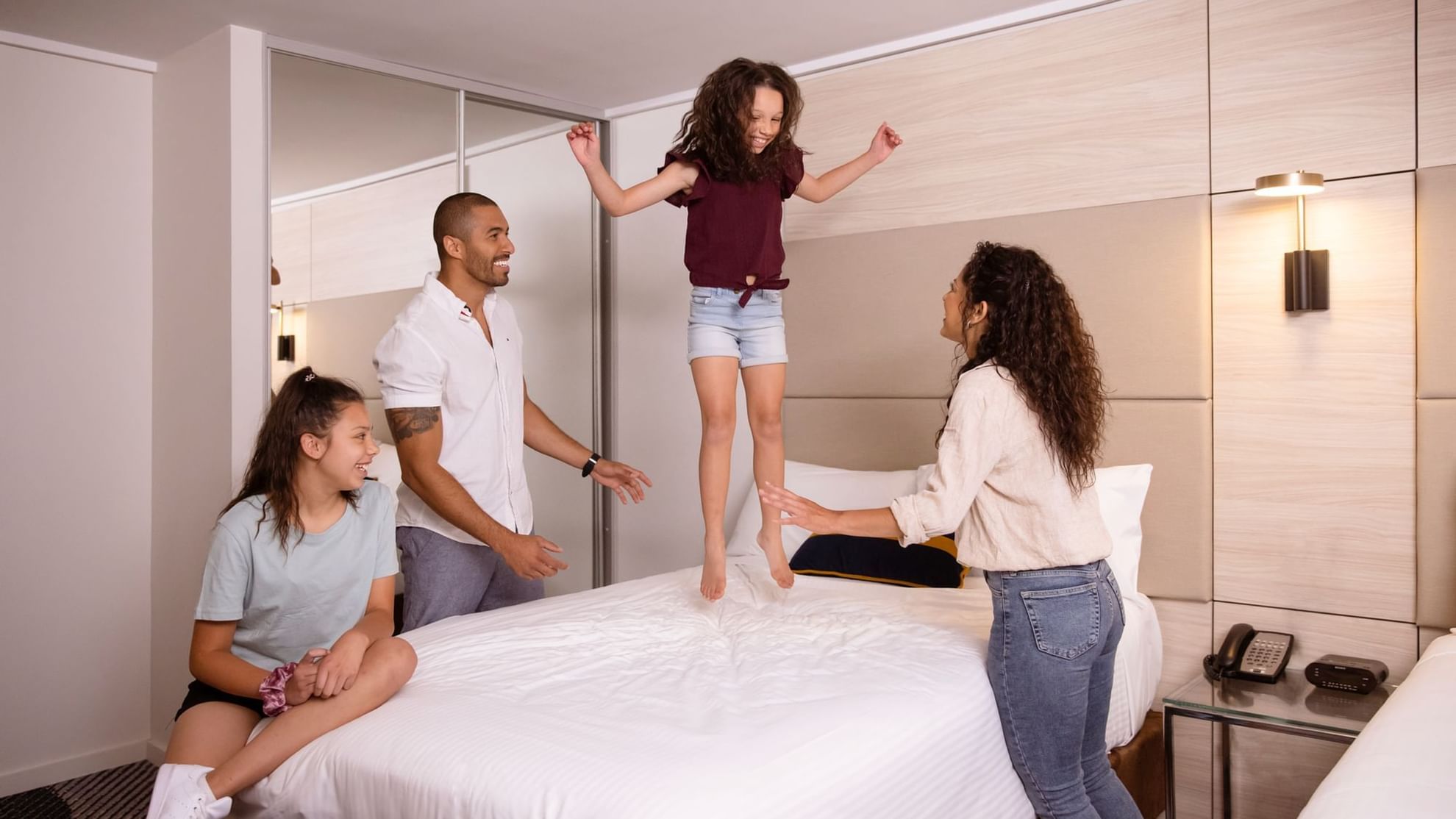 Standard Twin with family jumping on bed
