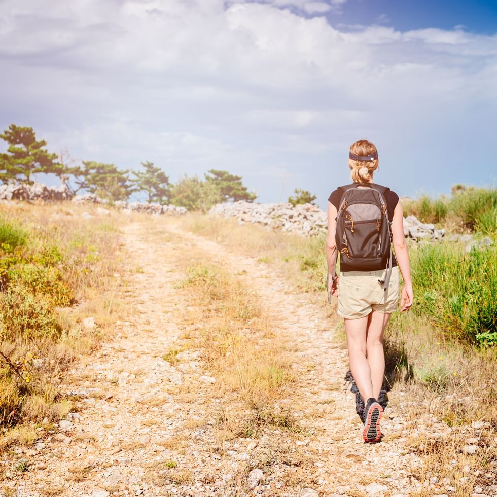 A woman trekking near Falkensteiner Hotels