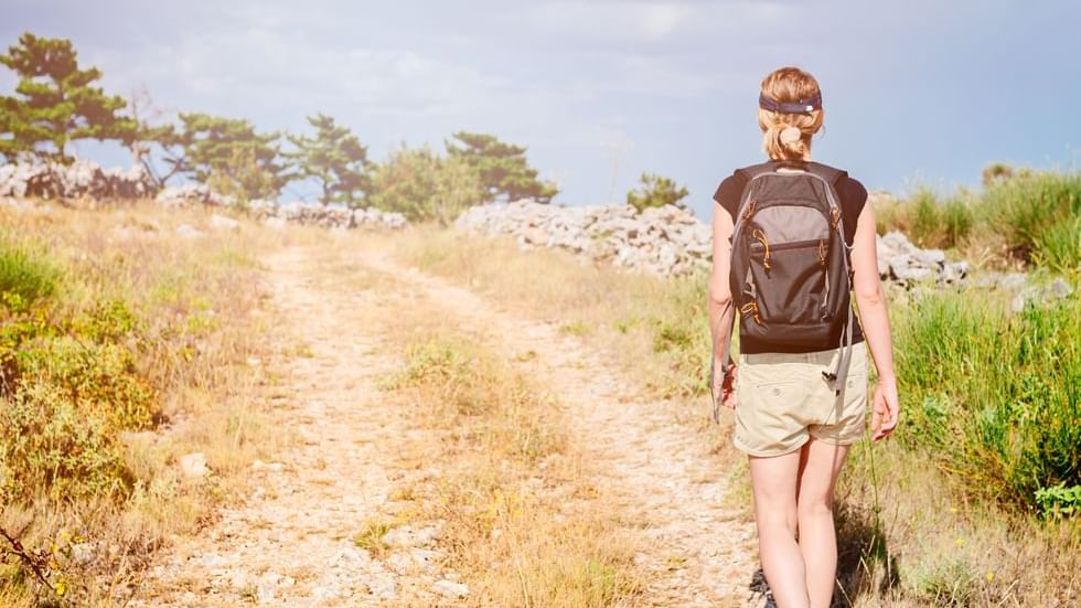 A woman trekking near Falkensteiner Hotels