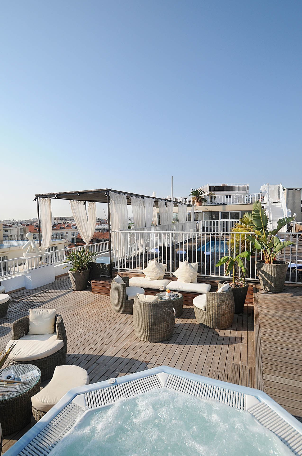 Outdoor relaxing area arranged with a jacuzzi at Splendid Hotel & Spa Nice