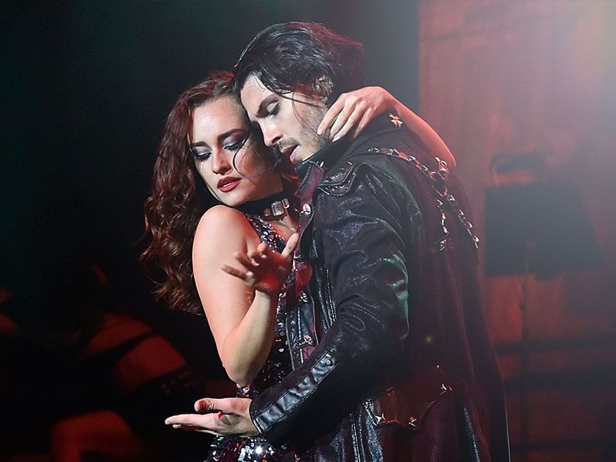 Intense performance scene featuring a man in a black leather coat and a woman embracing on stage at The Sebel Brisbane