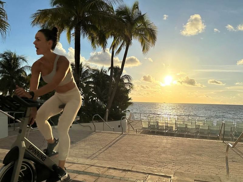 Woman cycling on an exercise machine at The Diplomat Resort