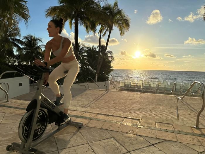 Woman cycling on an exercise machine at The Diplomat Resort