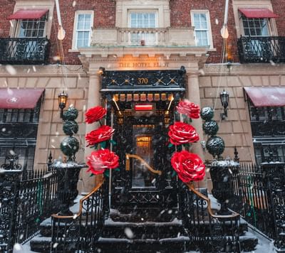 Red roses framing the entrance of The Eliot Hotel