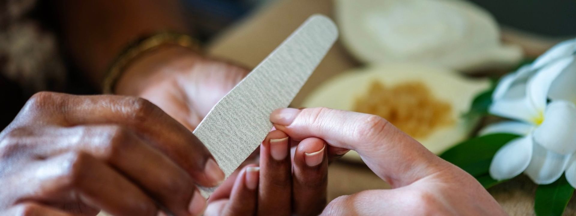 Hands receiving nail care with a nail file at The Joy Spa, The Naviti Resort in Korolevu