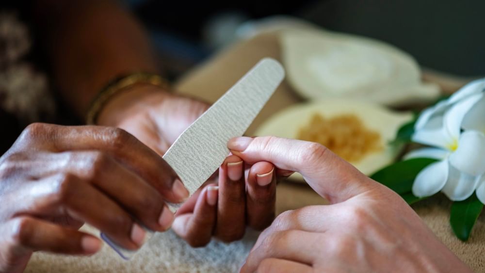Hands receiving nail care with a nail file at The Joy Spa, The Naviti Resort in Korolevu.