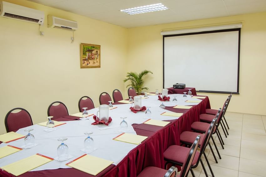 Modern Lantana Conference Room with large meeting table, chairs, and AV equipment at Bay Gardens Hotels and Resorts