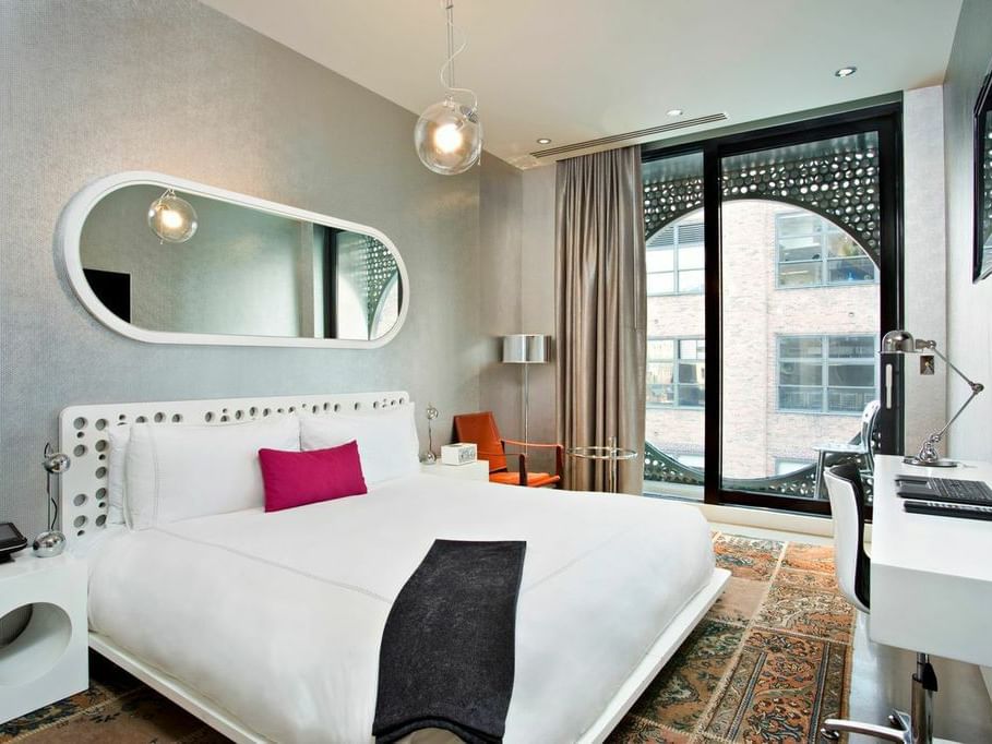 Bedroom of Bronze King balcony with king bed at Dream Downtown