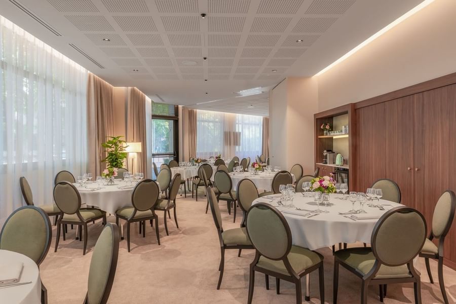 Banquet set-up with wooden shelves and soft lighting in the Astrid Salon at Warwick Reine Astrid - Lyon