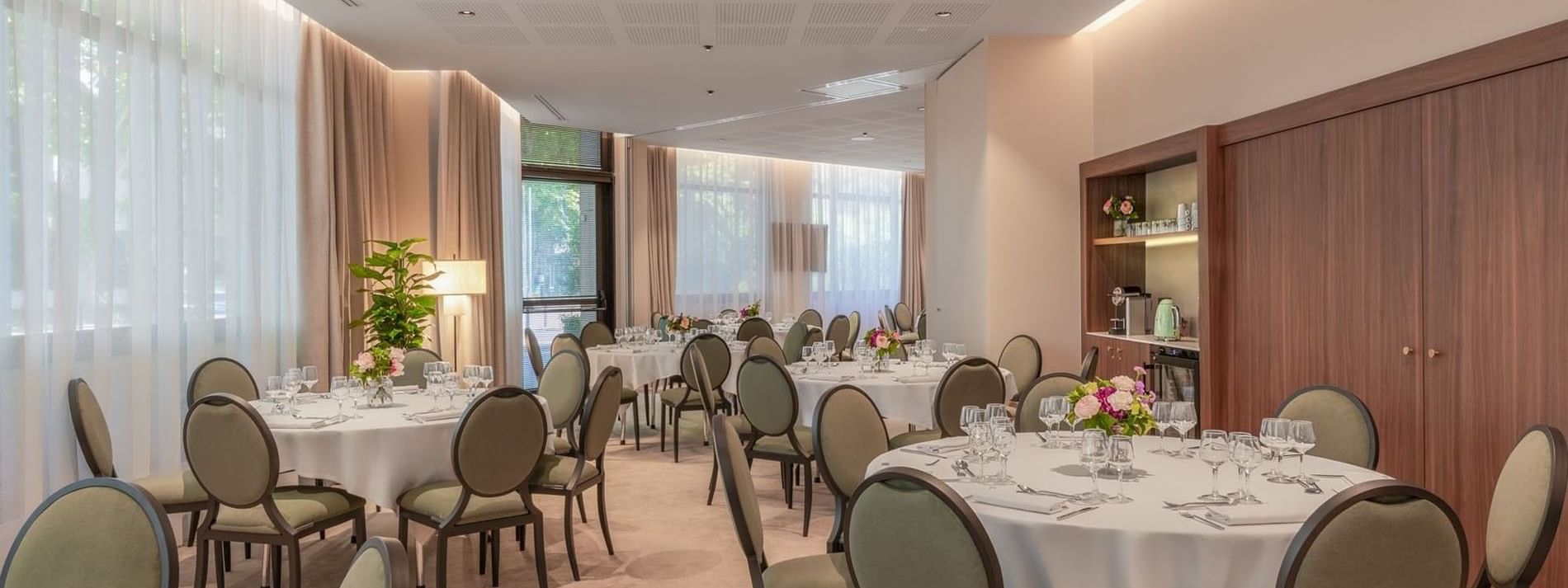 Banquet set-up with wooden shelves and soft lighting in the Astrid Salon at Warwick Reine Astrid - Lyon