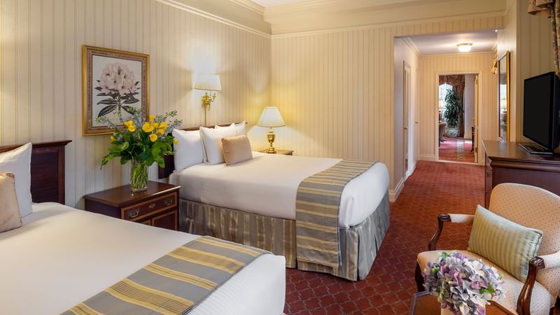 Two comfy beds with side tables in Suite of the Stars at Warwick New York