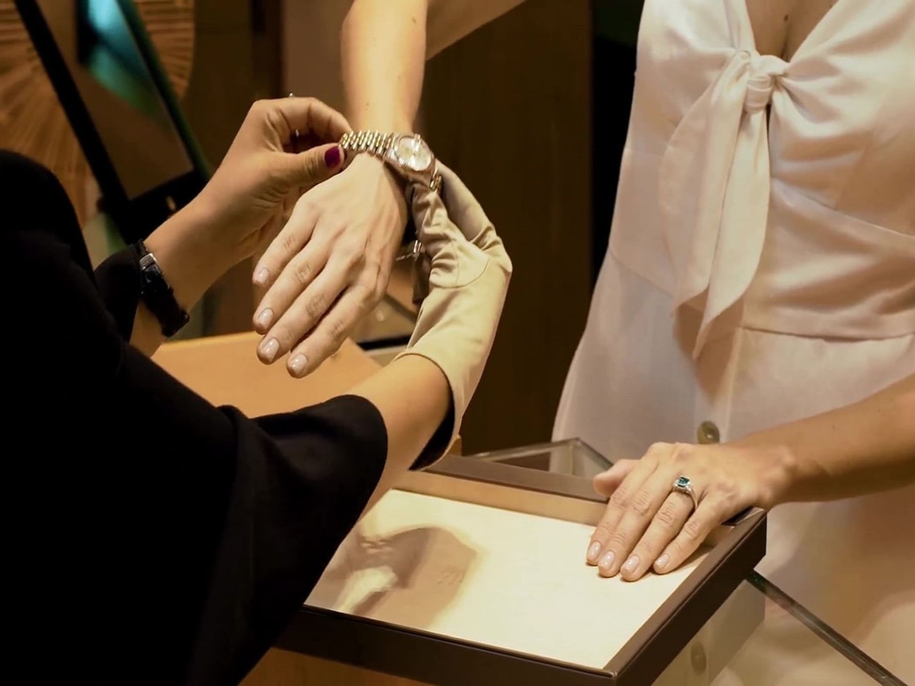 A woman trying a watch in the jewelry store at Hotel Charleston