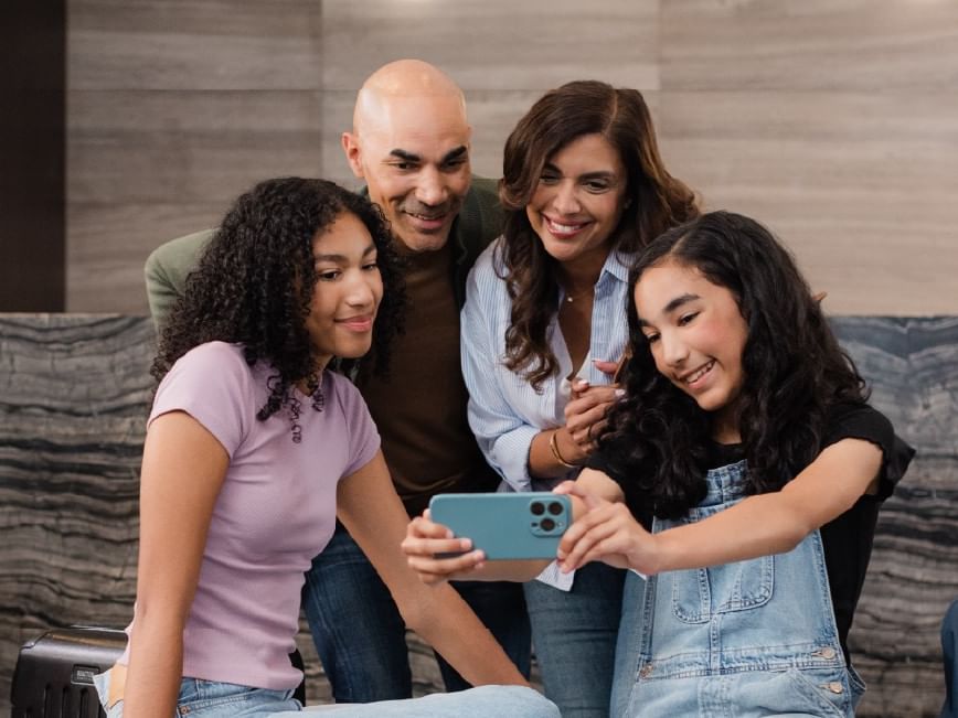 Family taking a selfie together with Boxing Week Sale offer.