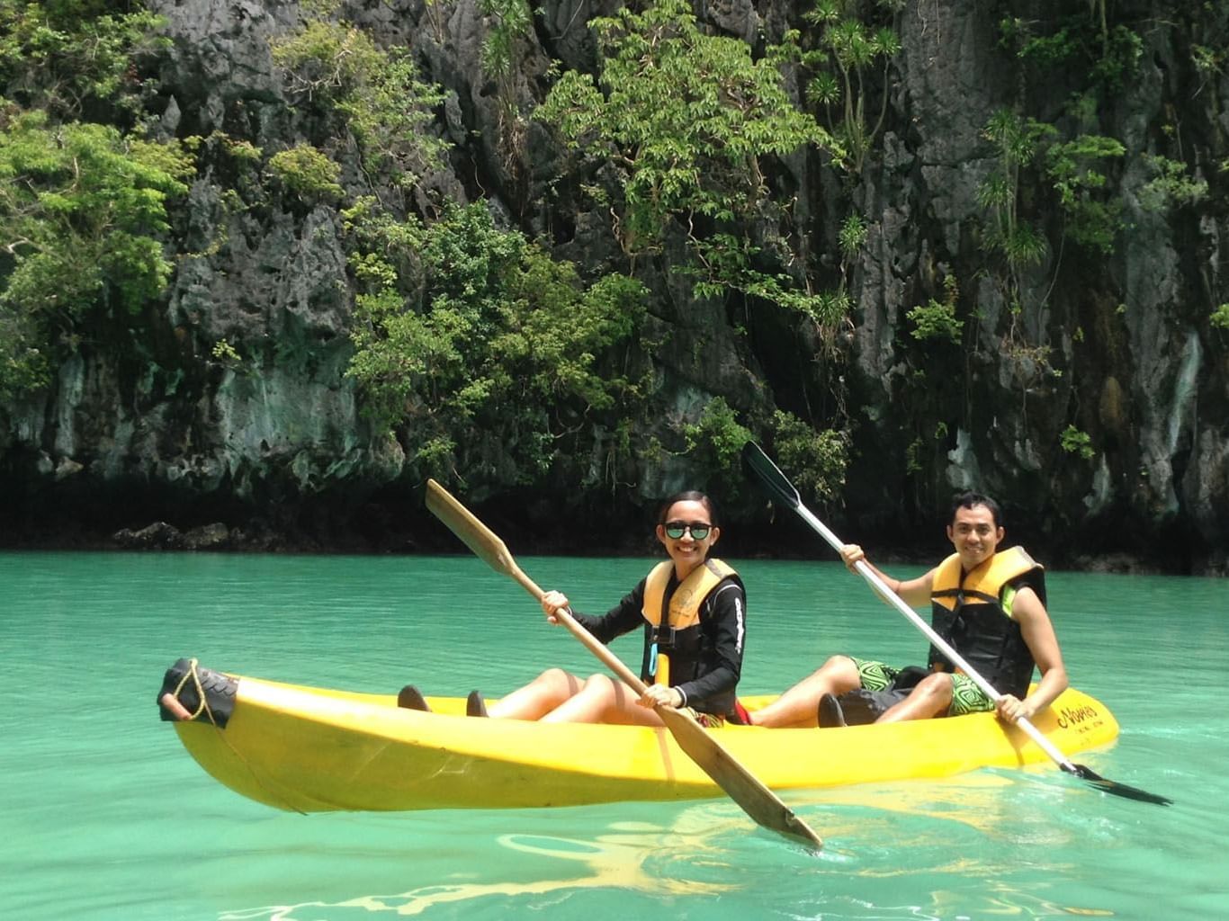 Couple kayaking in an ocean near Tanjung Rhu Resort Langkawi