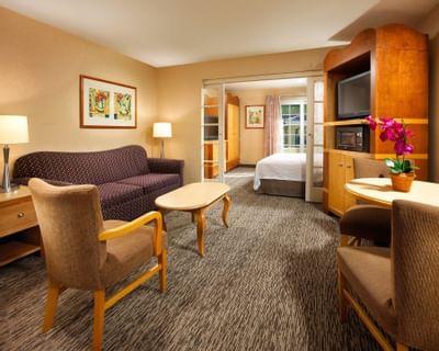 Interior of living room in King Suite at Anaheim Portofino Inn, budget-friendly suites near Disneyland for large families