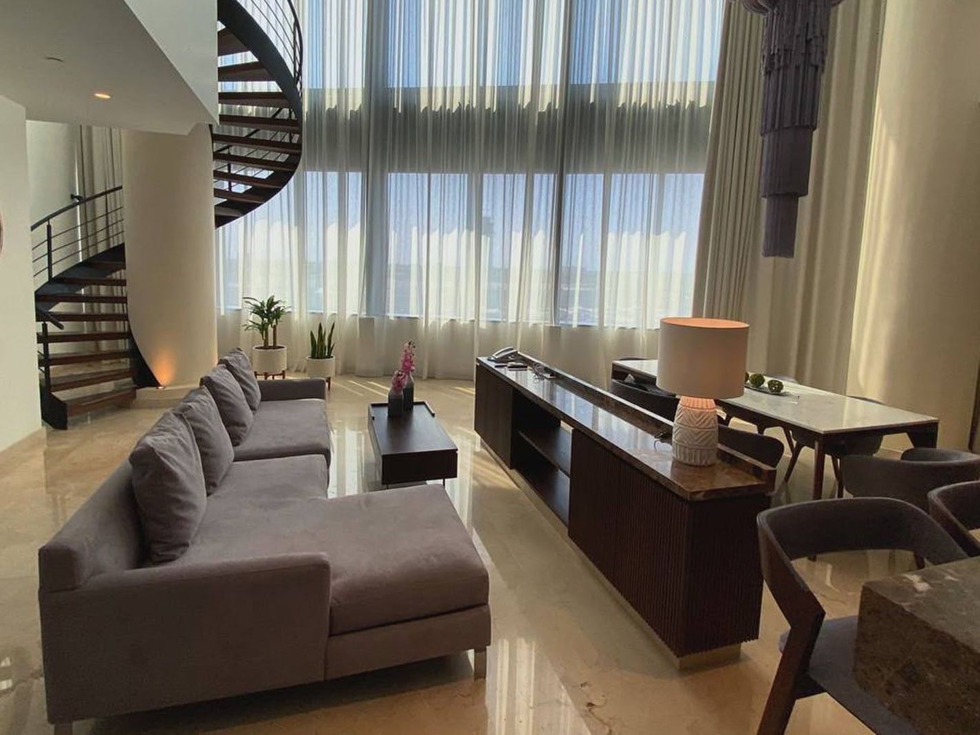 King Presidential Suite featuring a spiral staircase, high ceilings, and a sophisticated dining area at Camino Real Merida