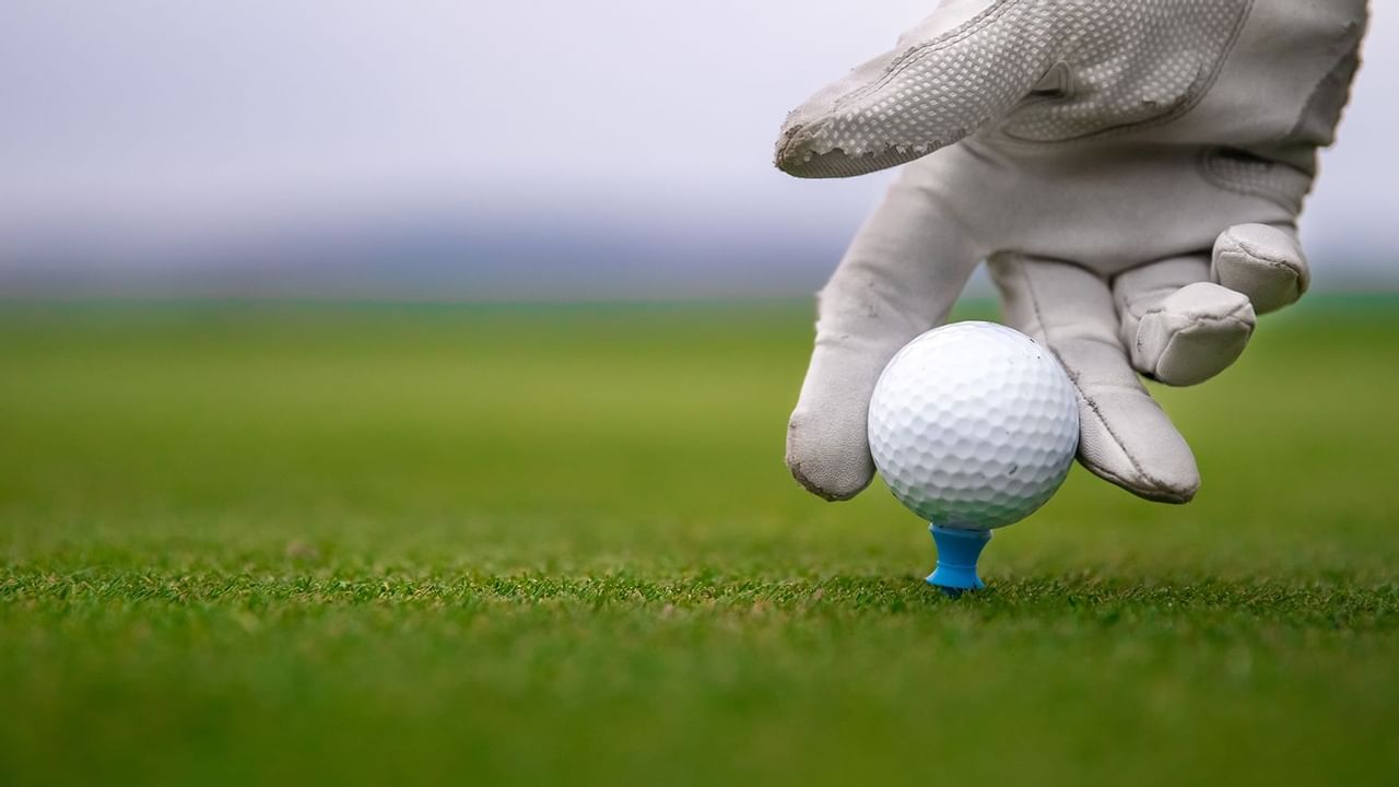 Placing a golf ball on a golf tee at The Oceanside Hotel