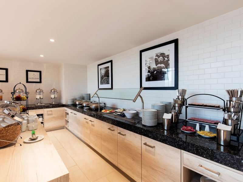 Clean buffet area in the Breakfast Room at Hampton Inn by Hilton Cancun Cumbres with hot food stations & silverware