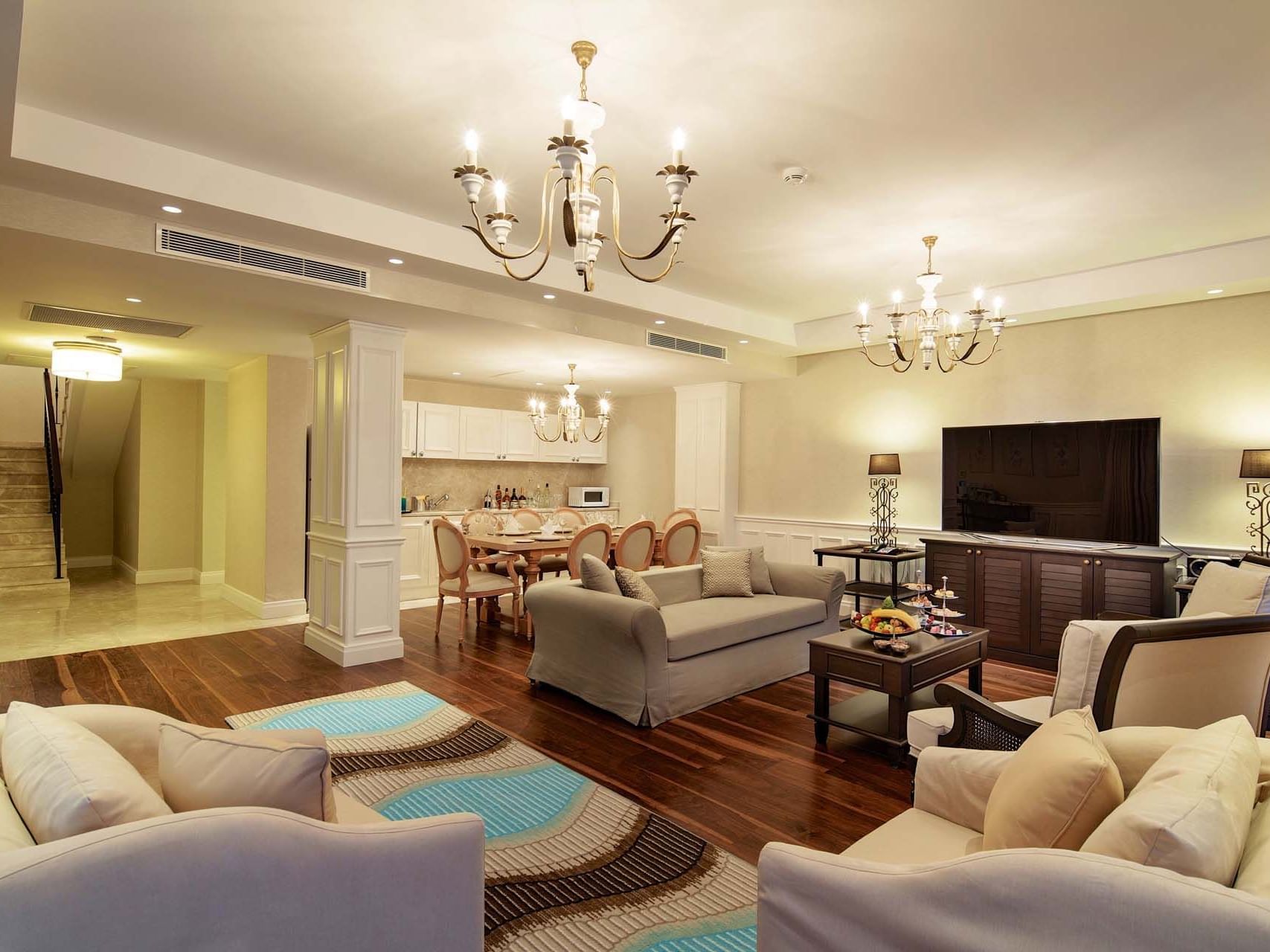 TV lounge area with wooden floors in Superior Villa at Titanic Deluxe Golf Belek