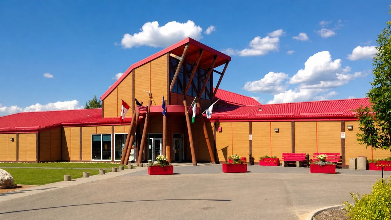 Flags and red planters outside the Forest Interpretive Centre and John & Audrey Dahl Heritage Park.