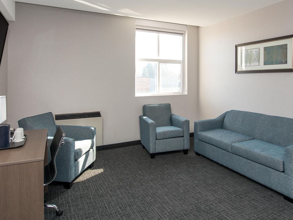 Living area with couch and two chairs.