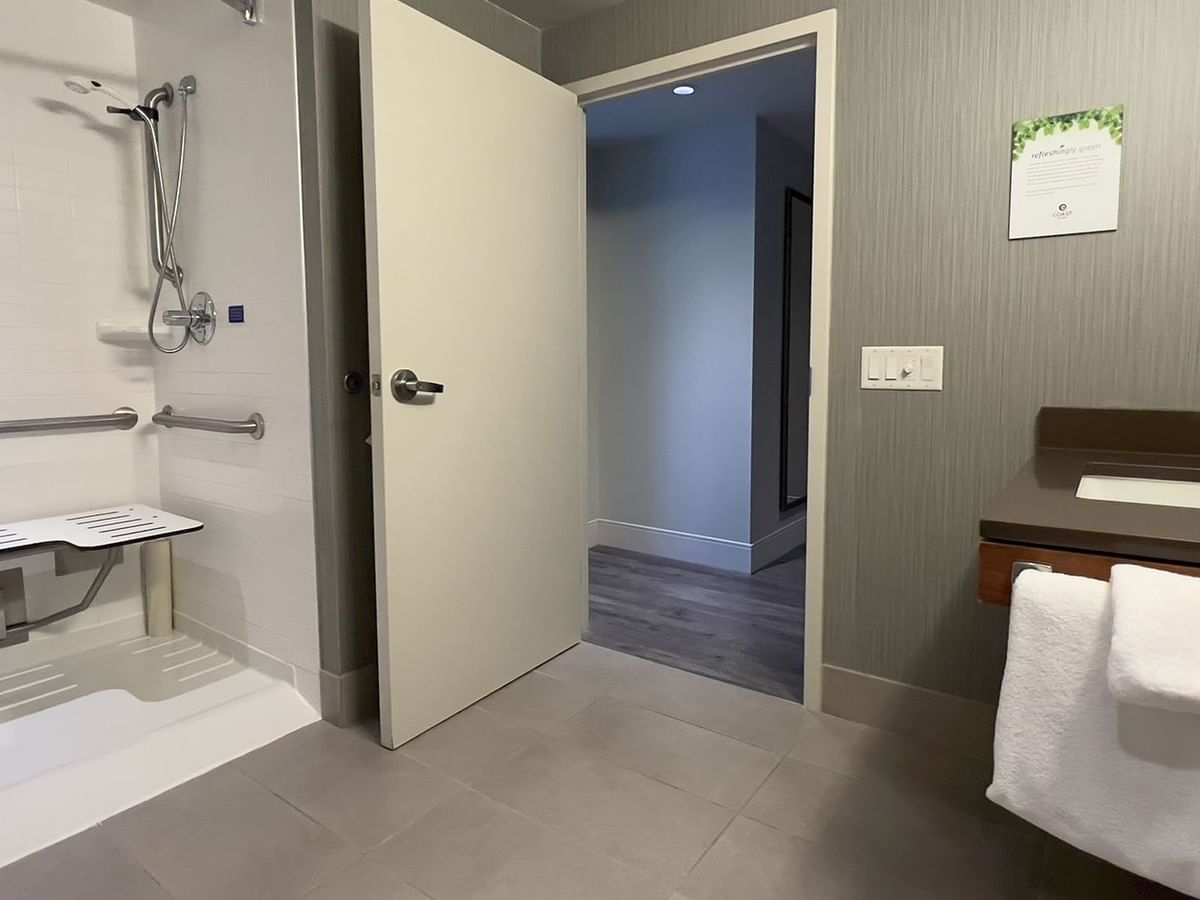 Accessible bathroom with sink, towels, and shower