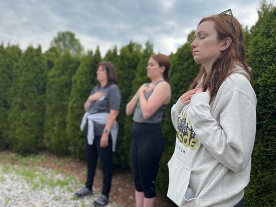 2 women meditating in a park near Honor's Haven Retreat