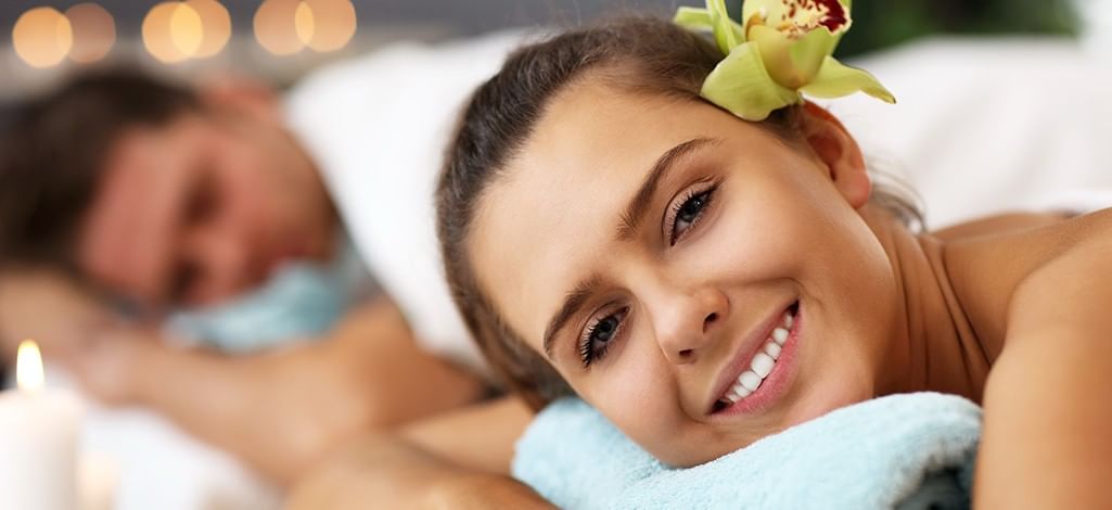Woman smiling while receiving a relaxing massage at a spa