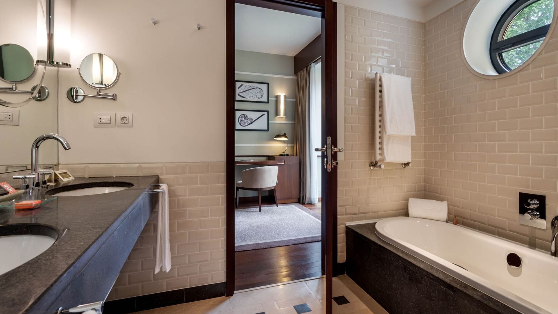 Bathroom vanity & bathtub in a Suite at Bensaude Hotels Collection