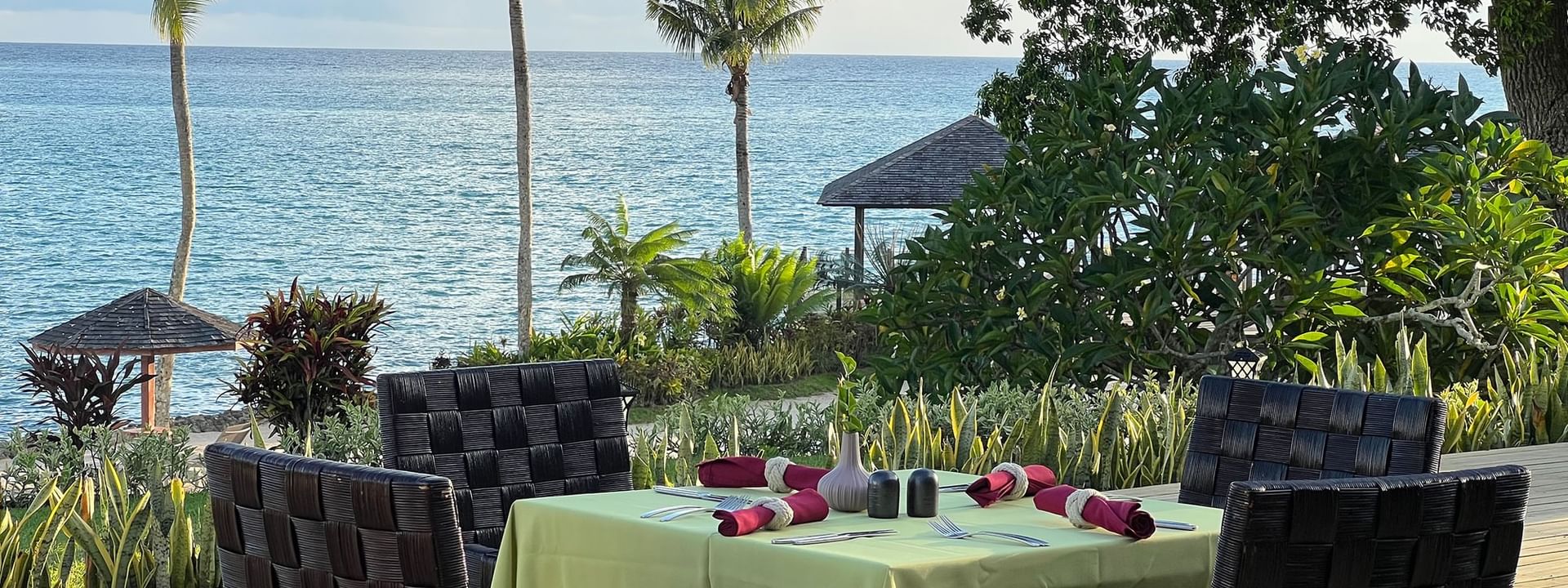 Outdoor dining area with ocean view at Wild Ginger Restaurant & Bar in Efate at Warwick Le Lagon - Vanuatu