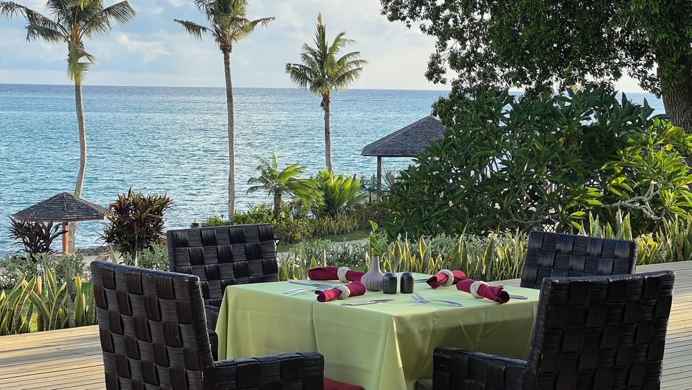 Outdoor dining area with ocean view at Wild Ginger Restaurant & Bar in Efate at Warwick Le Lagon - Vanuatu.