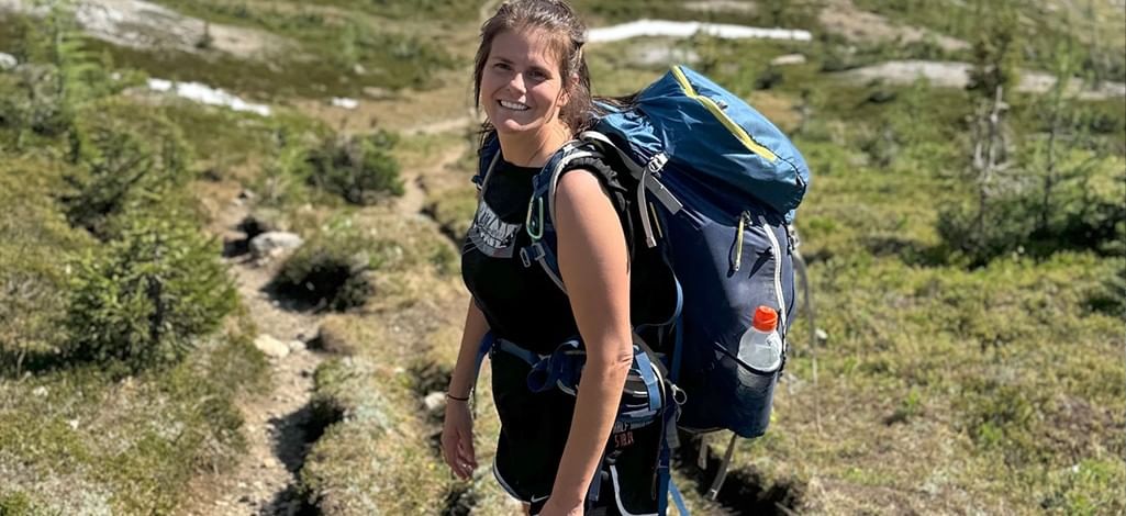 A person hikes with a hiking backpack on a trail in Banff National Park.