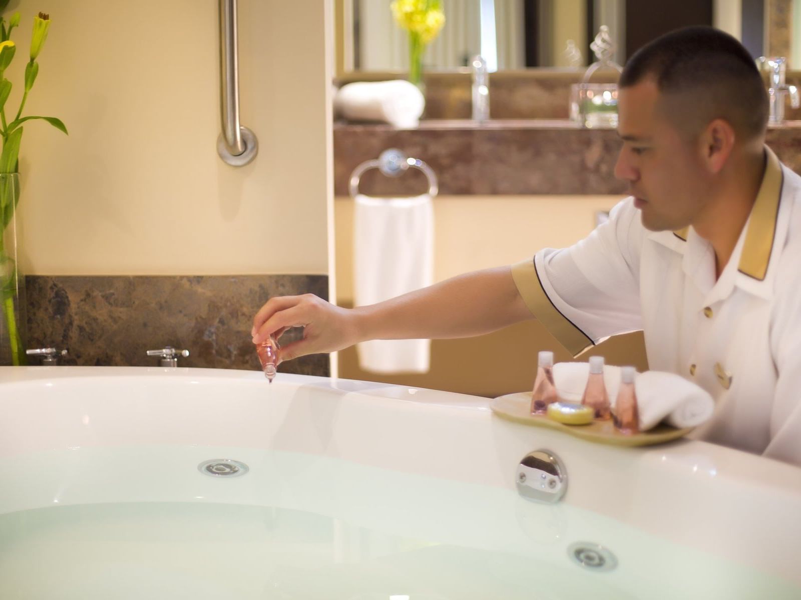 person preparing bath at Sunset Plaza Beach Resort