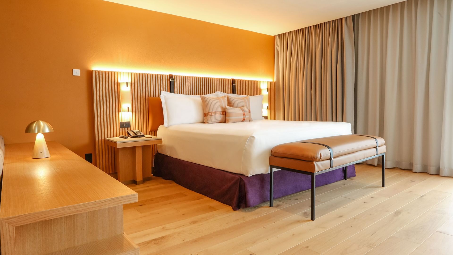 King Superior Junior Suite with a large bed and warm decor at Camino Real Polanco Mexico in Ciudad de Mexico.
