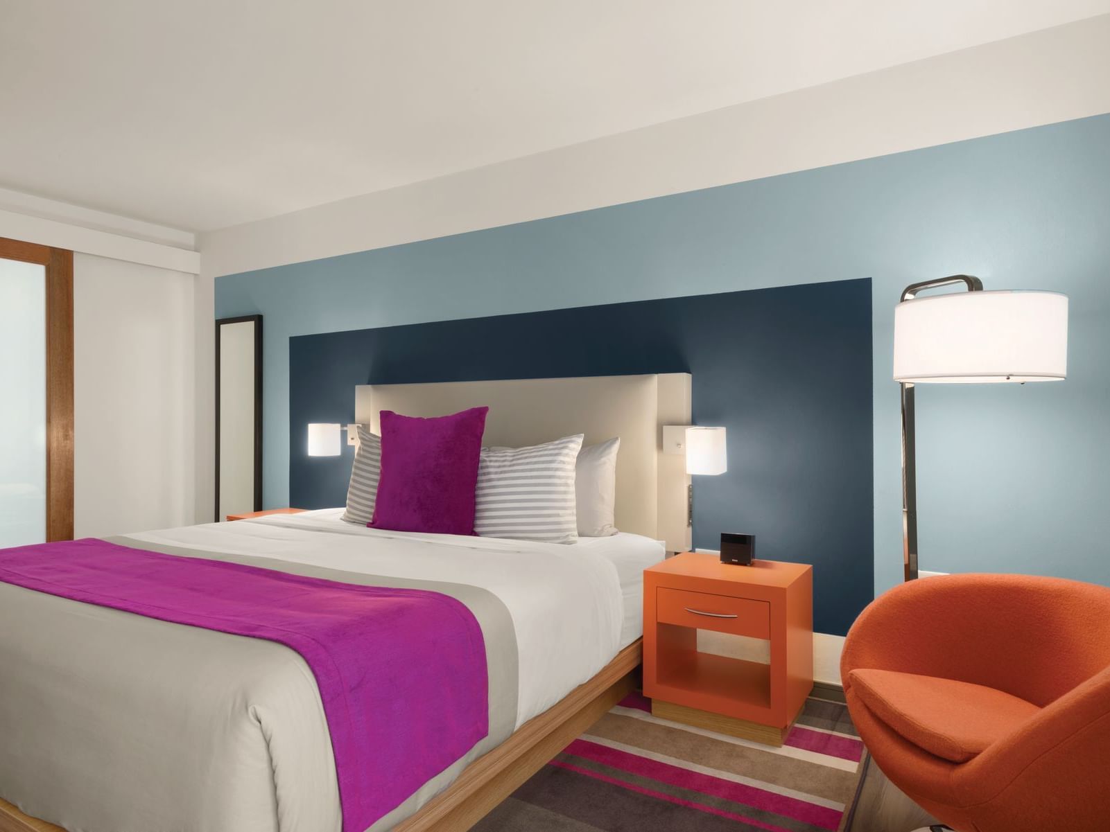 TRYP by Wyndham Isla Verde room with king bed, accent chair and lamp