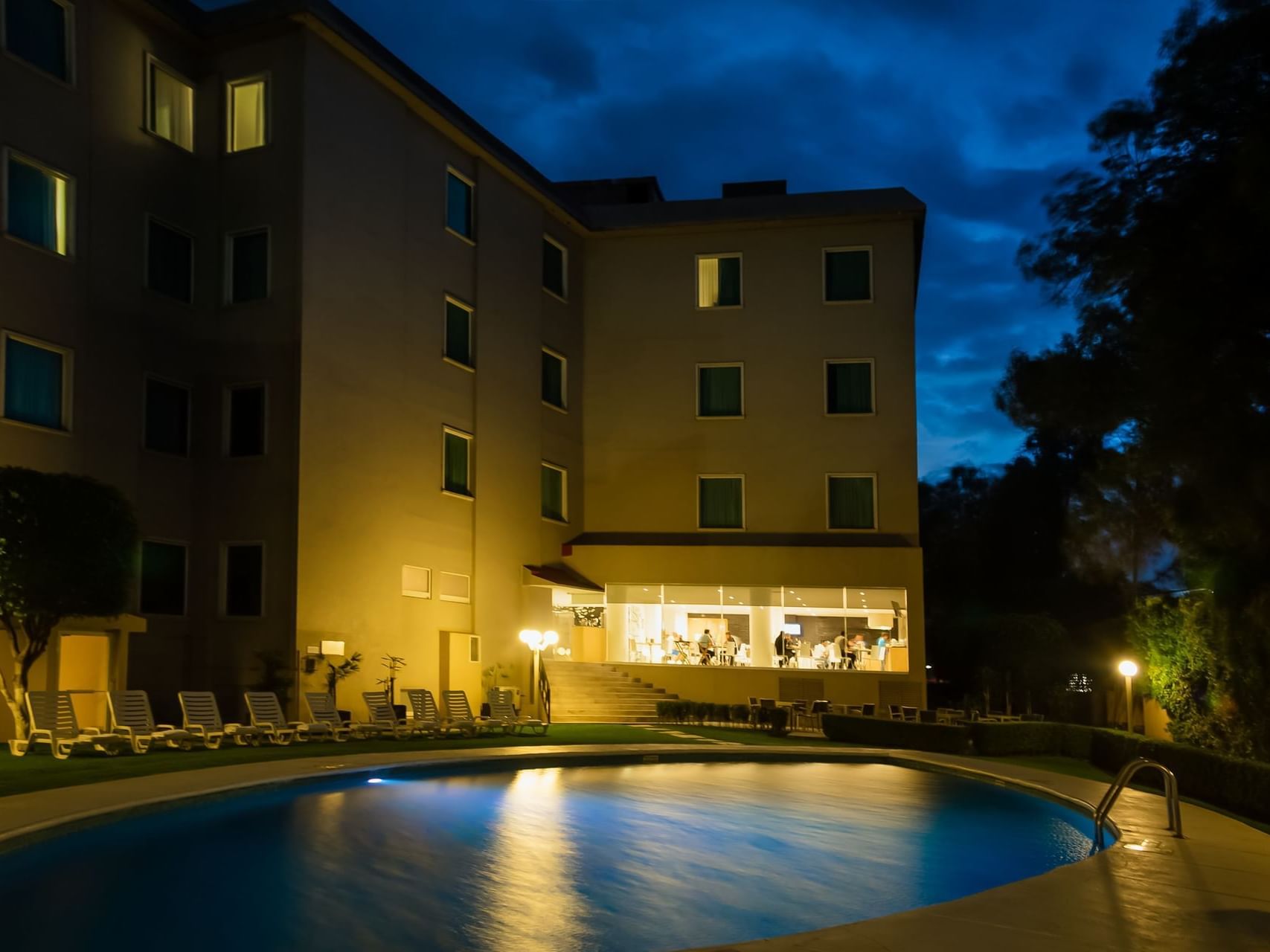 Night view of the outdoor swimming pool area at Fiesta Inn
